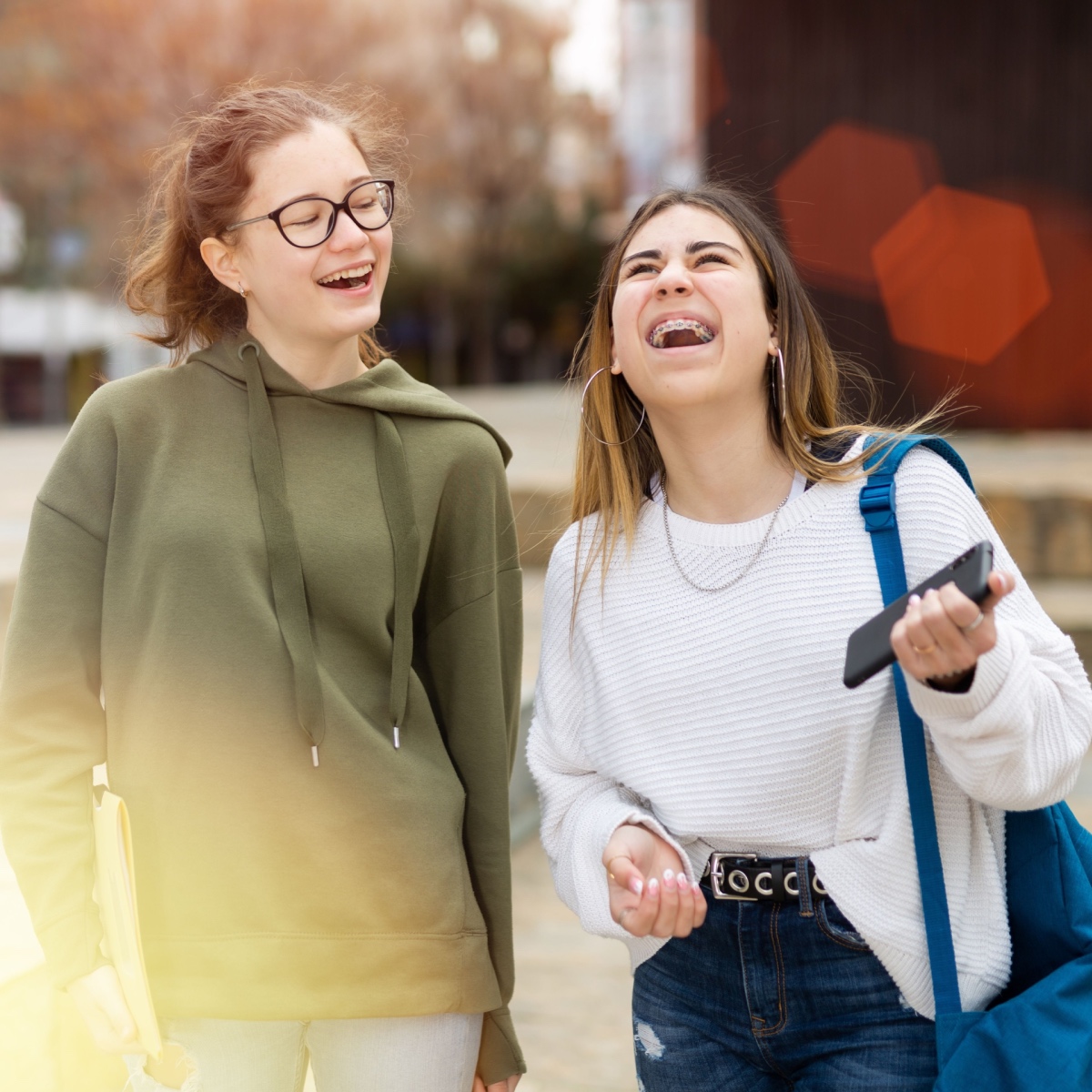 A girl with Houston braces laughing with her friend