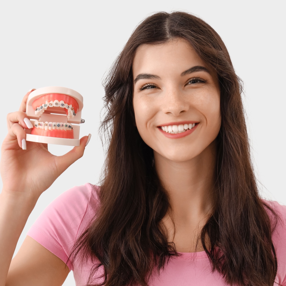 A young woman smiling while holding South Houston braces